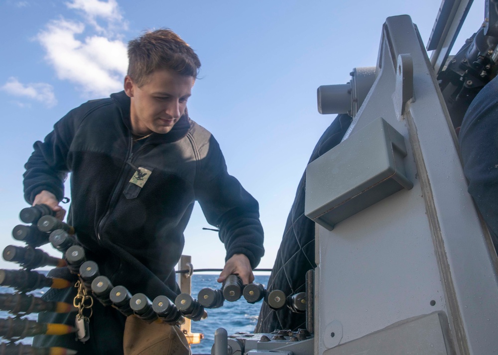 Sailor Loads Machine Gun