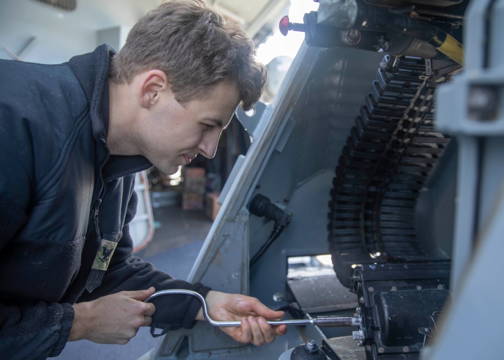 Sailor Loads Machine Gun