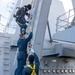 Sailors Perform Maintenance on Sliding Padeye