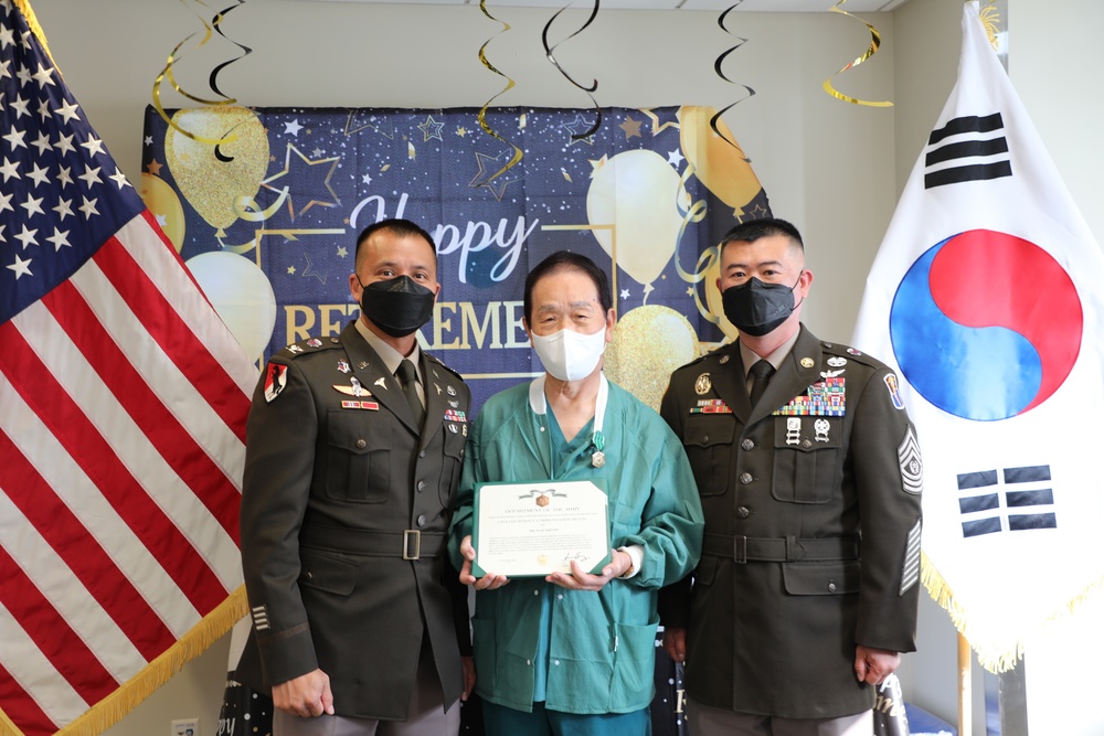 Mr. Sim receives the civilian service commendation medal