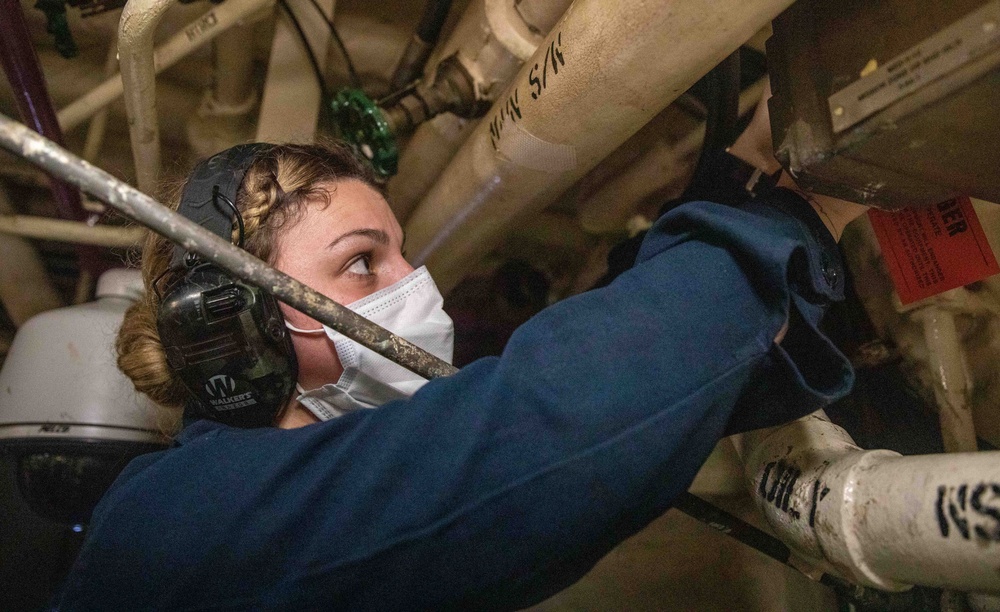 USS Milwaukee Sailor Conducts Tag Outs in the Engine Room