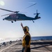 USS Billings Sailor Launches a MH-60S Sea Hawk Helicopter