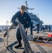 USS Milwaukee Sailor Heaves Line on the Fo’c’sle