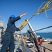 USS Milwaukee Sailor Throws Line to Workers on the Pier