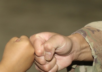 Fist bumps all the rage among Afghan children, American Soldiers in Qatar