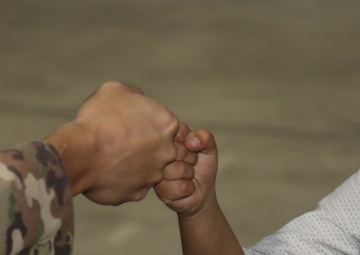 Fist bumps all the rage among Afghan children, American Soldiers in Qatar