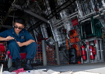USS Charleston Sailor Conducts Maintenance on Equipment