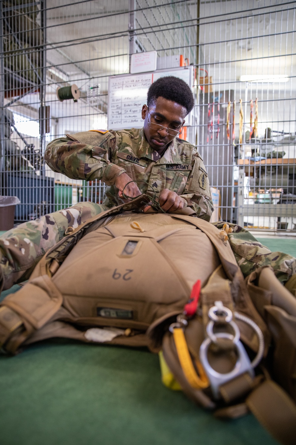 10th SFG riggers pack and inspect parachutes