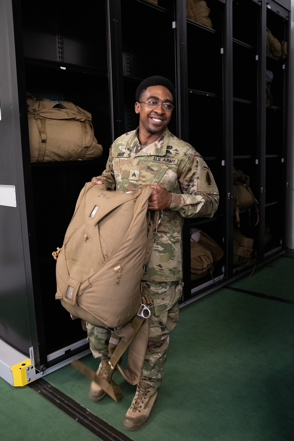 10th SFG riggers pack and inspect parachutes