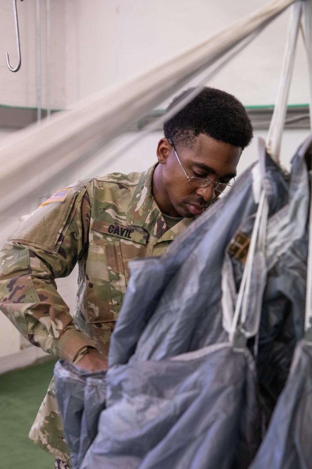 10th SFG riggers pack and inspect parachutes