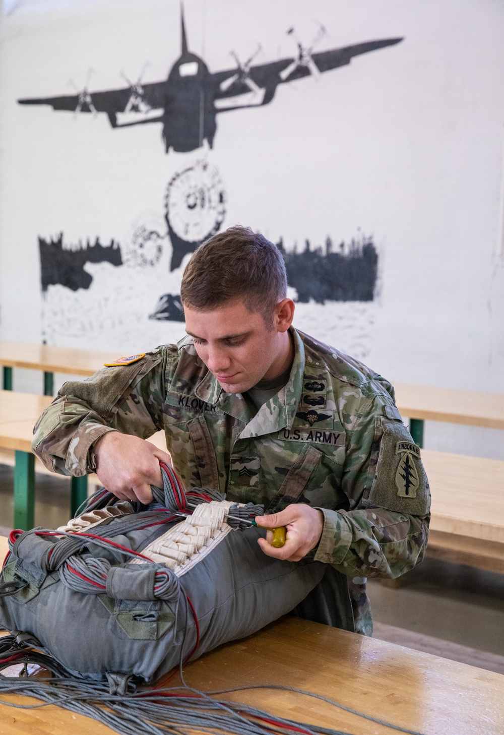 10th SFG riggers pack and inspect parachutes