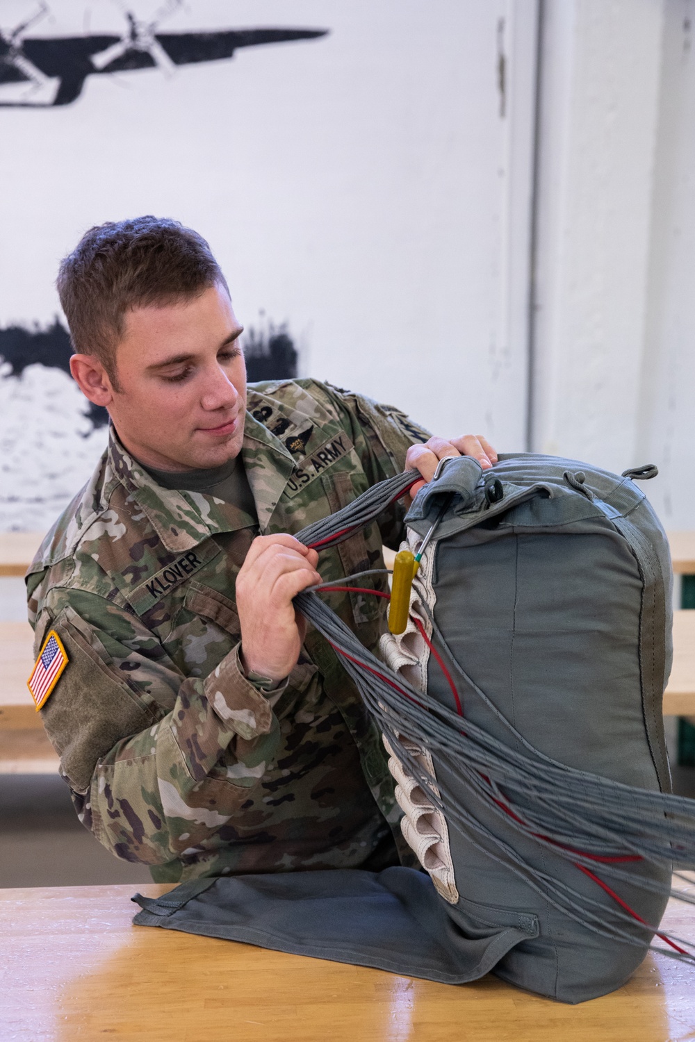 10th SFG riggers pack and inspect parachutes