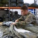 10th SFG riggers pack and inspect parachutes