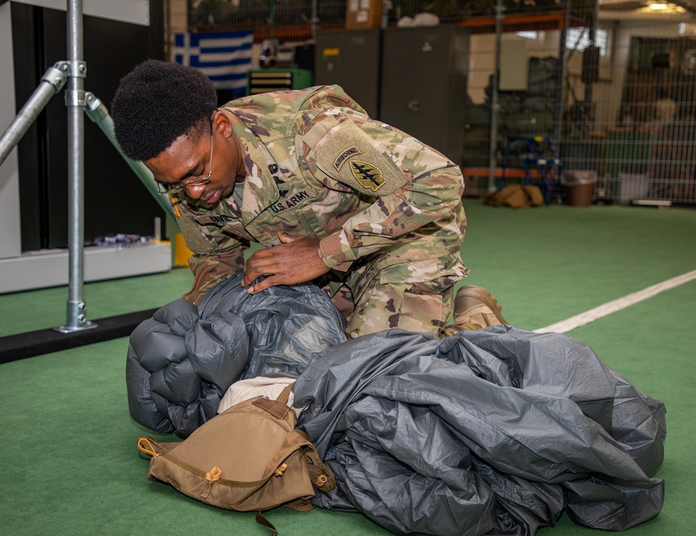 10th SFG riggers pack and inspect parachutes