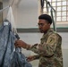 10th SFG riggers pack and inspect parachutes