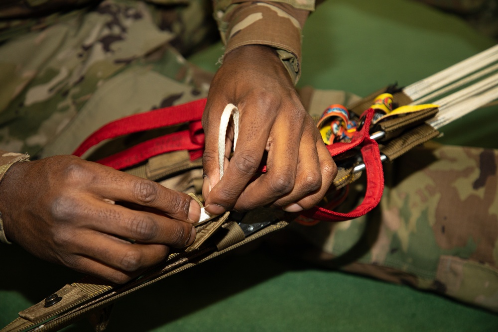 10th SFG riggers pack and inspect parachutes