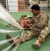 10th SFG riggers pack and inspect parachutes