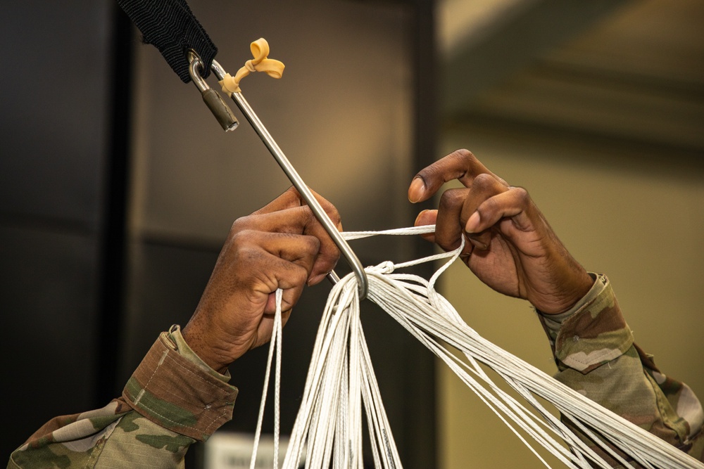 10th SFG riggers pack and inspect parachutes