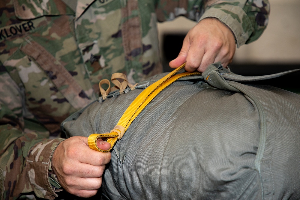 10th SFG riggers pack and inspect parachutes