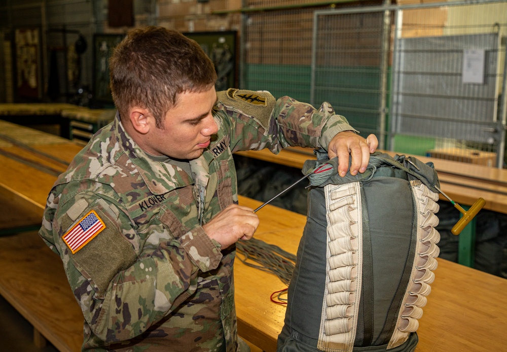 10th SFG riggers pack and inspect parachutes