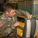 10th SFG riggers pack and inspect parachutes