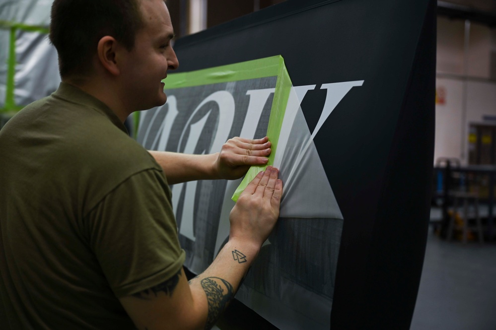 Structurally sound: Aircraft Maintenance Airmen apply a decal