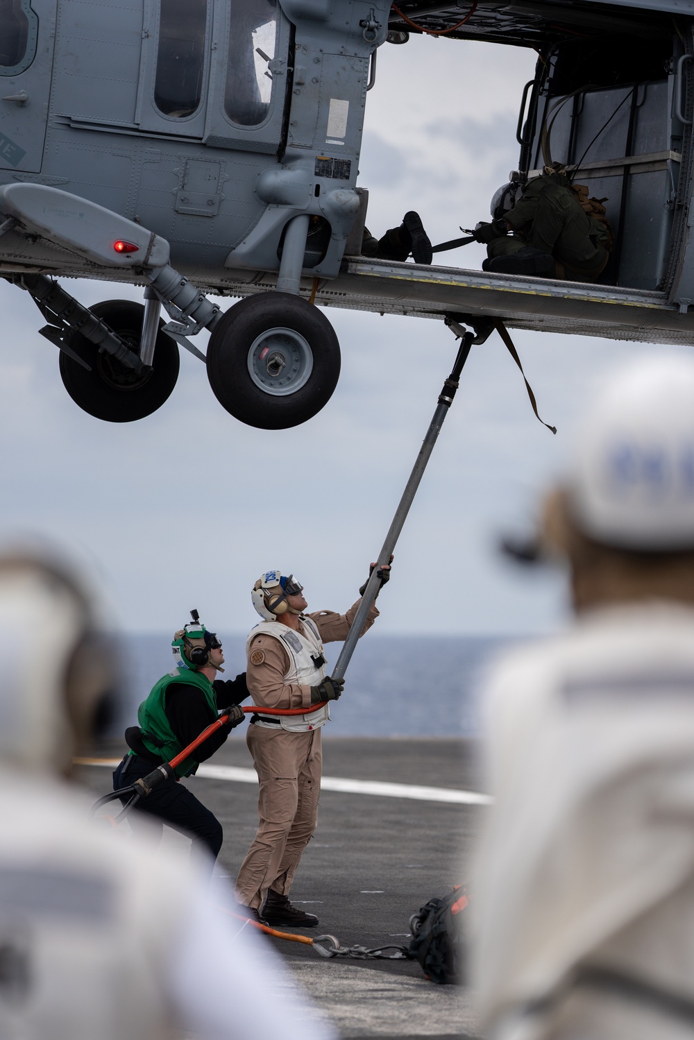 Commander Carrier Strike Group 1 goes hands-on in vertical replenishment.