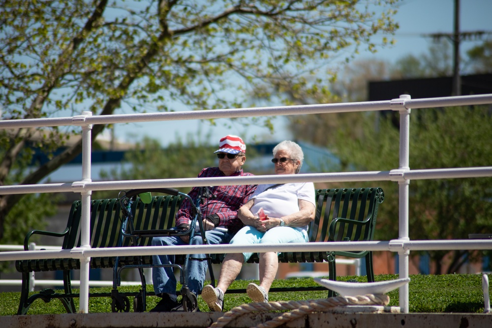 Couple Attentively Listens to Christening Ceremony