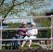 Couple Attentively Listens to Christening Ceremony