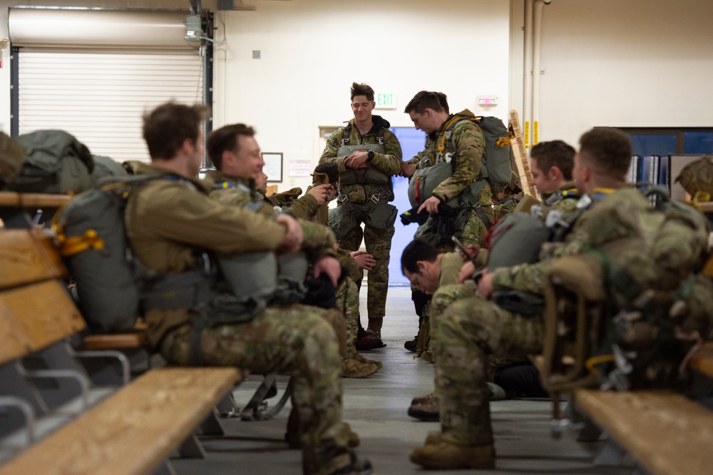 Air Force tactical air control party specialists and combat weather airmen prepare for airborne operations at JBER