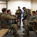 Air Force tactical air control party specialists and combat weather airmen prepare for airborne operations at JBER