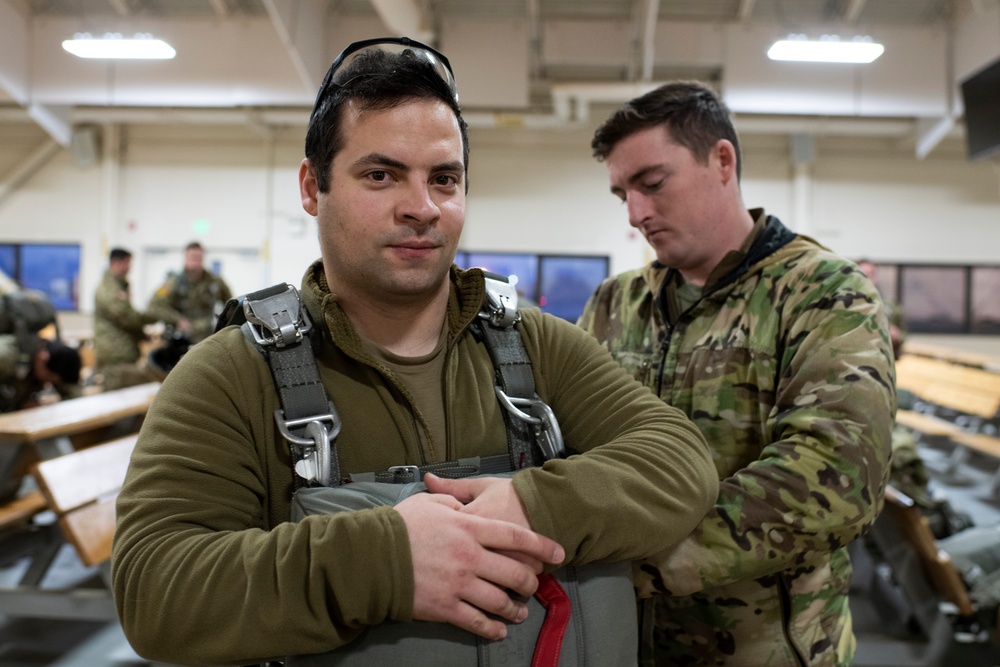 Air Force tactical air control party specialists and combat weather airmen prepare for airborne operations at JBER