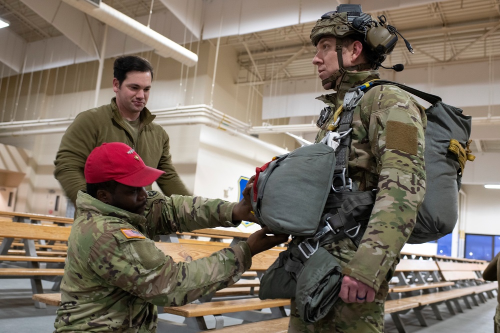 Air Force tactical air control party specialists and combat weather airmen prepare for airborne operations at JBER