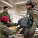 Air Force tactical air control party specialists and combat weather airmen prepare for airborne operations at JBER