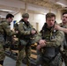 Air Force tactical air control party specialists and combat weather airmen prepare for airborne operations at JBER