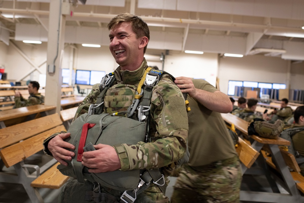 Air Force tactical air control party specialists and combat weather airmen prepare for airborne operations at JBER