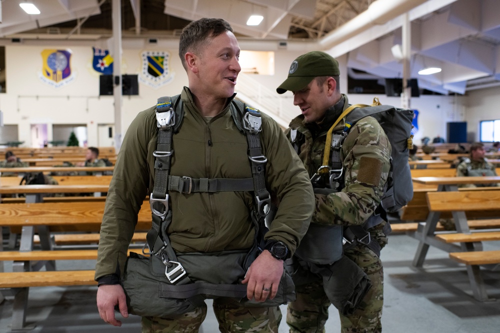 Air Force tactical air control party specialists and combat weather airmen prepare for airborne operations at JBER