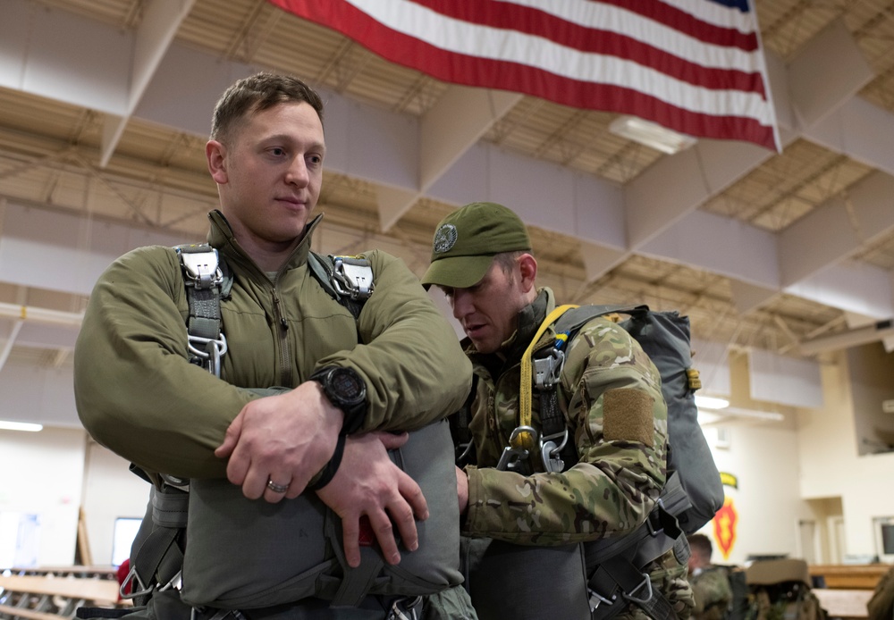 Air Force tactical air control party specialists and combat weather airmen prepare for airborne operations at JBER