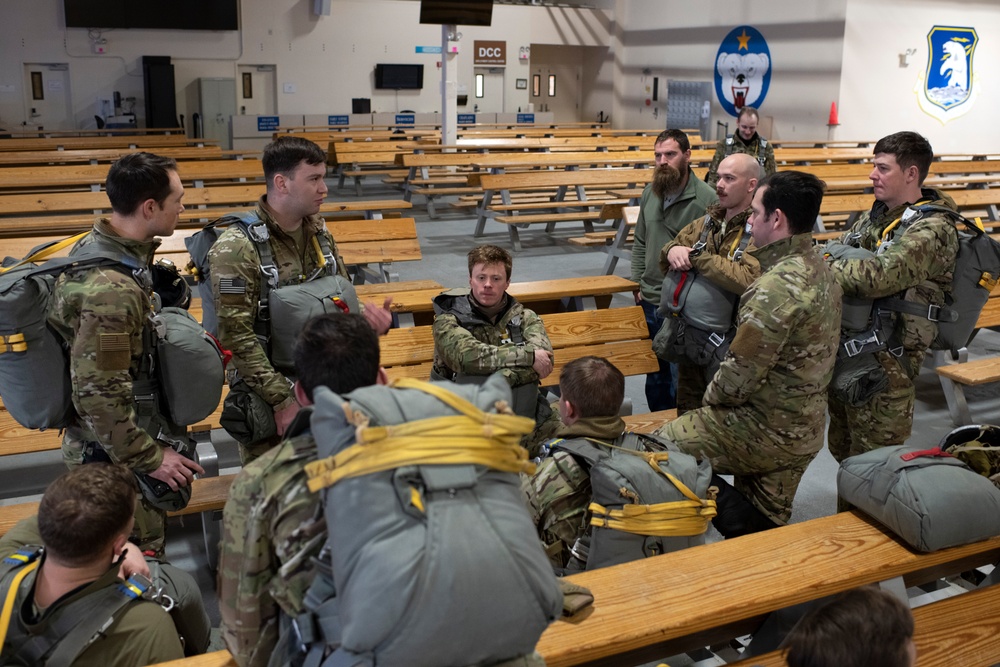 Air Force tactical air control party specialists and combat weather airmen prepare for airborne operations at JBER