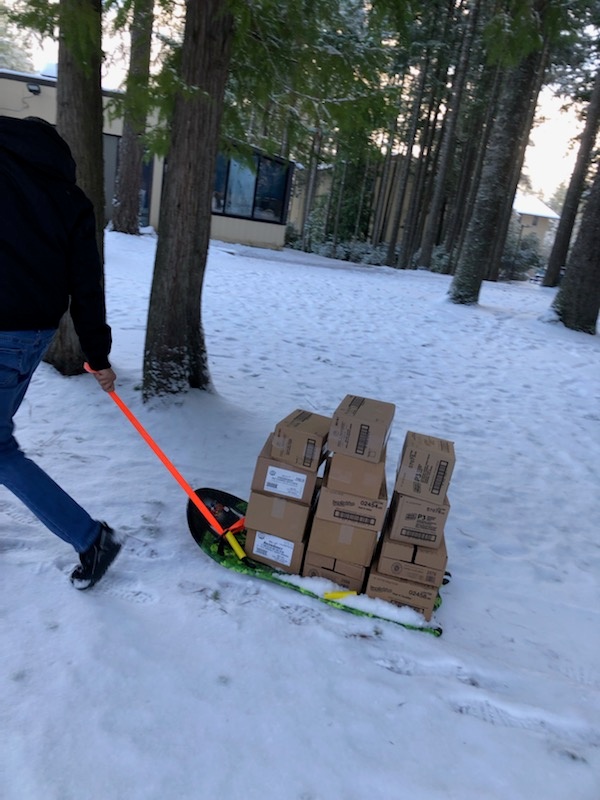 NEX Bangor associates delivery good via sled