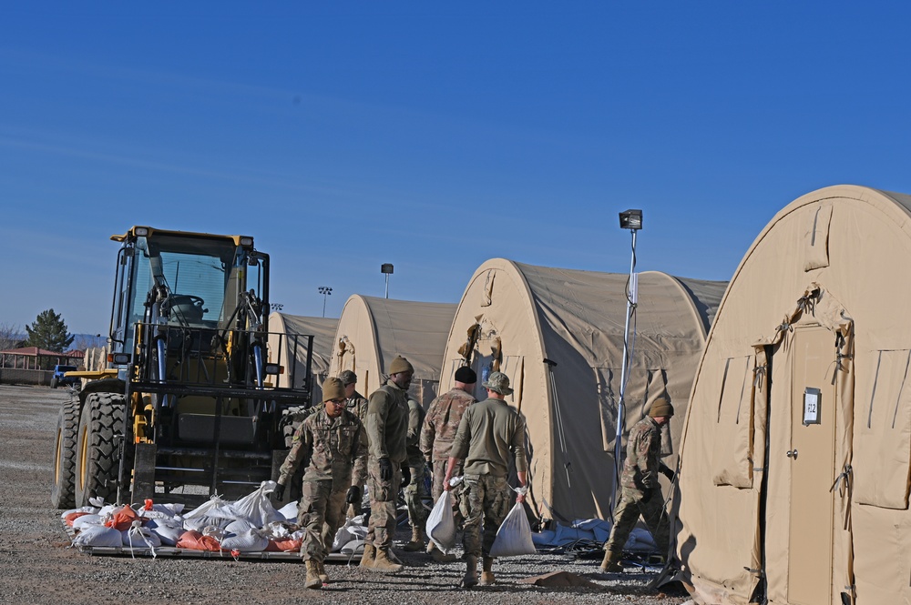 Task Force Holloman Airmen remove sand bags from the Life Support Area