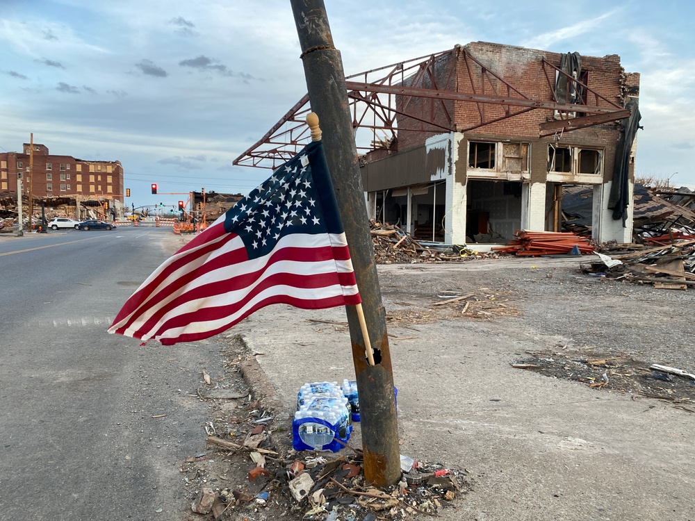 A Flag Blows in the Wind in Downtown Mayfield, Kentucky Were a Tornado Recently Ravished the Town