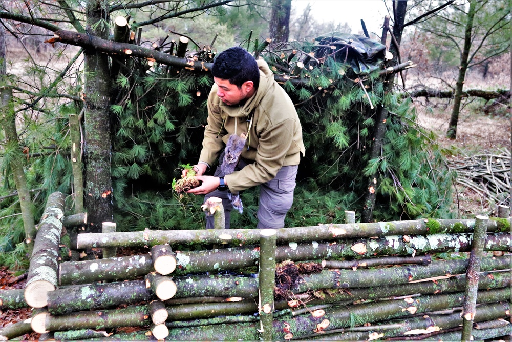 Building improvised shelters for Fort McCoy's Cold-Weather Operations Course