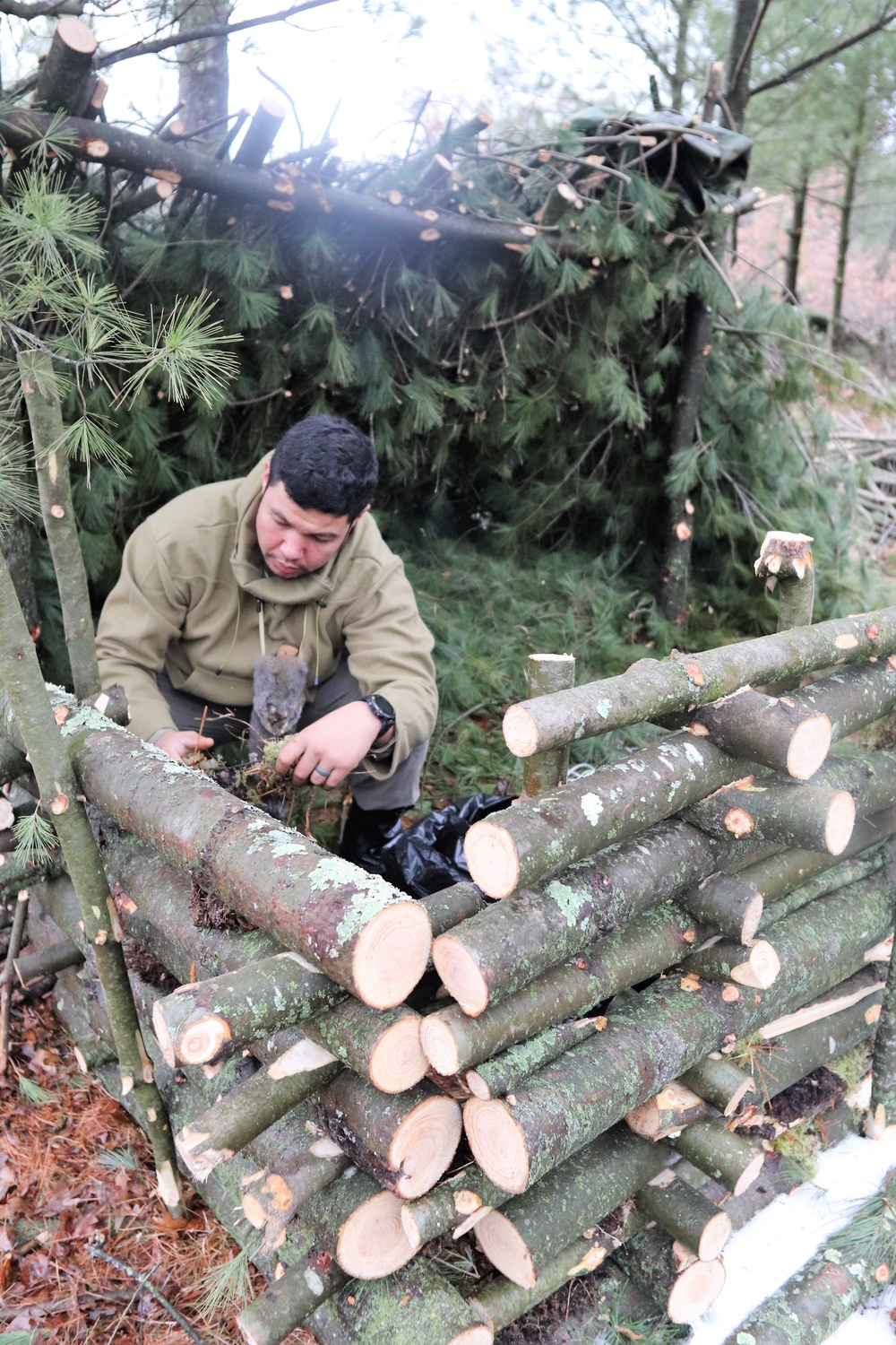 Building improvised shelters for Fort McCoy's Cold-Weather Operations Course