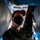 The Harry S. Truman Carrier Strike Group is on a scheduled deployment in the U.S. Sixth Fleet area of operations in support of naval operations to maintain maritime stability and security. A military service member wearing camouflage uniform and a black face mask is photographed from a low angle between two large cylindrical objects, likely munitions or ordnance. The perspective is taken from below, looking up between the cylindrical items toward the person's face. The individual appears to be inspecting or handling the equipment.