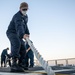 USS Milwaukee Sailor Heaves Line on the Flight Deck