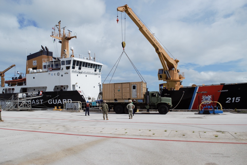 US Navy Seabees with NMCB-5 and UCT 2 unload gear from the U.S. Coast Guard Cutter Sequoia (WLB 215) onboard Naval Base Guam