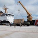US Navy Seabees with NMCB-5 and UCT 2 unload gear from the U.S. Coast Guard Cutter Sequoia (WLB 215) onboard Naval Base Guam
