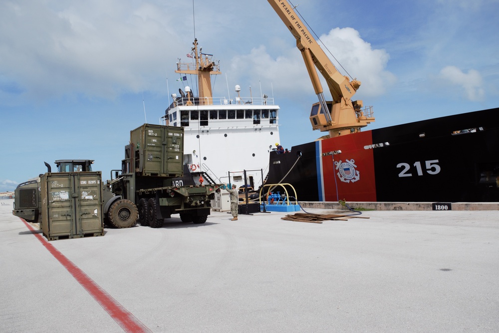 US Navy Seabees with NMCB-5 and UCT 2 unload gear from the U.S. Coast Guard Cutter Sequoia (WLB 215) onboard Naval Base Guam