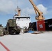 US Navy Seabees with NMCB-5 and UCT 2 unload gear from the U.S. Coast Guard Cutter Sequoia (WLB 215) onboard Naval Base Guam